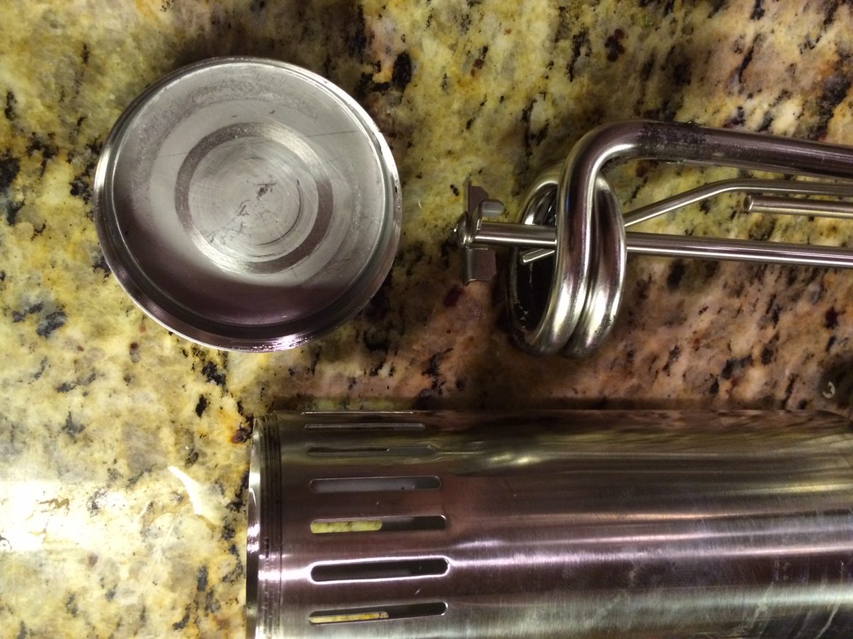 With the sleeve on, the ports are evenly spaced. The bottom cup has an opening for the pump that can be angled relative to the container