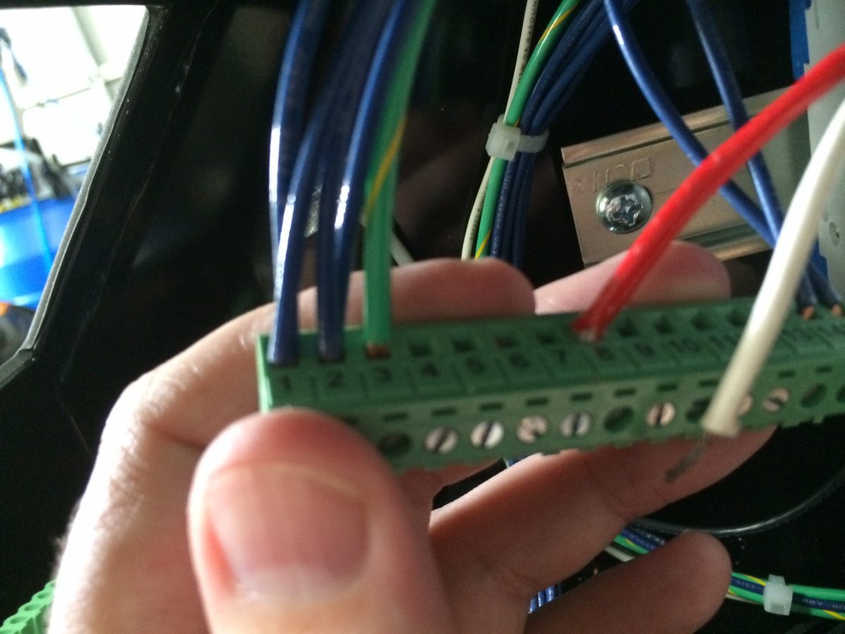 At the back of the wiring strip are little screws that clamp the wires into position. Carefully release the wires, and insert into the proper position. You will need to tighten the screws for the pin position until the wire stays put with a tug.